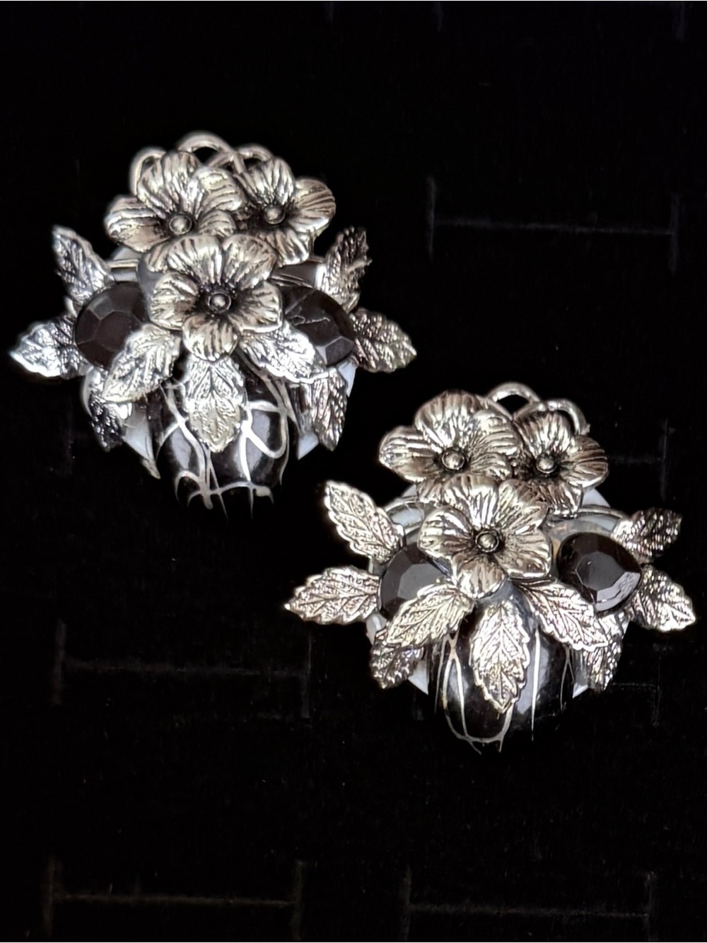 Vintage raised floral, silvertone and black clip on earrings